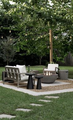 a fire pit sitting on top of a lush green field