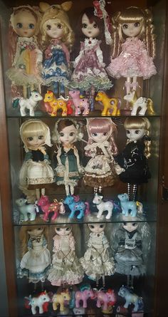 a display case filled with lots of little dolls