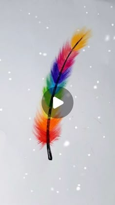 a colorful feather is flying through the air