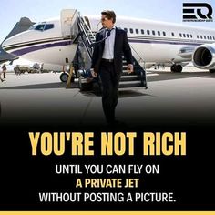 a man in a suit walking towards an airplane with the caption you're not rich until you can fly on a private jet without posting a picture