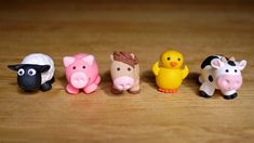 small toy farm animals lined up on a table