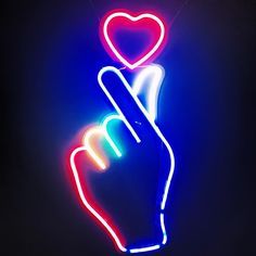 a neon sign with a hand holding a heart in the shape of a v on it