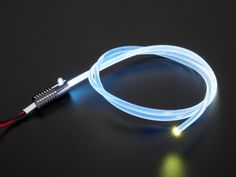 a light up cable on a black surface