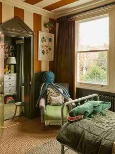 a bedroom decorated in green and orange with an octopus chair next to the bed,