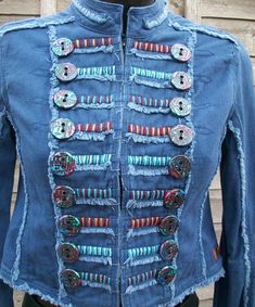 a blue jean jacket with buttons on it