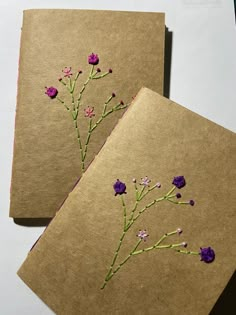 two brown cards with purple flowers on them