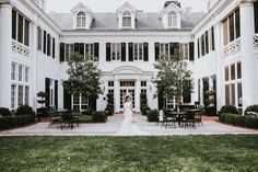 a bride standing in front of a large white building