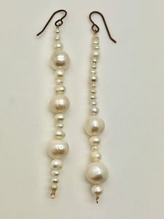 Mixed Pearls in graduated sizes presented on hand crafted solid bronze on bronze ear wire hooks. ♛ Hand crafted Solid Bronze ♛ 12mm Natural Freshwater Pearls ♛ 6mm Natural Freshwater Pearls ♛ 4mm Natural Freshwater Pearls ♛ Bronze Ear hooks ♛ Approximately 4 inches in length Every gem is hand picked and chosen for its color, beauty, & uniqueness. Every Icon is selected for its rarity, aesthetic significance, & natural provenance. Every completed object de' art is one of a kind & handmade in Scot Rarity Aesthetic, Hand Chain Bracelet, Skeleton Earrings, Freshwater Pearl Drop Earrings, Freshwater Pearls Earrings, Hand Chain, Pearl Earrings Dangle, Delicate Jewelry, Vintage Pearls