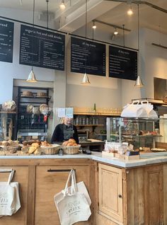 the interior of a bakery with menus hanging from the ceiling