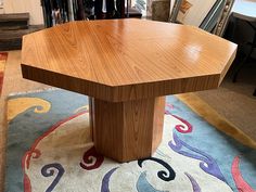 a wooden table sitting on top of a rug