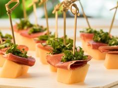 small appetizers with prosciutto, parsley and cheese on sticks