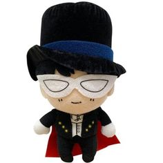 a small stuffed toy wearing a black hat and glasses with a red cape around his neck