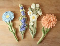 three cookies decorated with flowers on a table