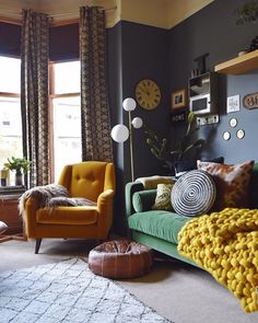 a living room filled with lots of furniture and decor on top of carpeted flooring