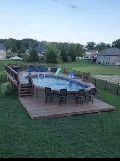 an above ground pool surrounded by wooden decking