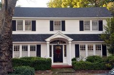 a large white house with black shutters