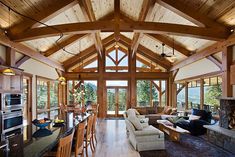 a living room filled with furniture and a fire place in the middle of a kitchen