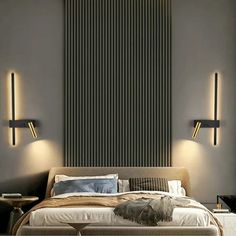 a bed with two lights on the wall above it