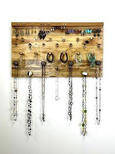 a wooden wall mounted with lots of jewelry