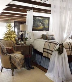 a bedroom decorated for christmas with white drapes and plaid bedspread on the bed