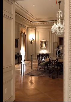 an elegant dining room with chandelier and chairs