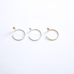 These Unique Earrings are designed to look like a two piece ear jacket but with the simplicity and ease of an ear threader. They are Simple and Modern enough to be worn on a daily basis. These tiny 3mm Balls come in either Brass, Sterling Silver or 14k Gold with 40mm sterling silver posts for the sterling and brass and 14k gold for the gold option. Delicate and minimalist earrings you must have for casual wear or minimalist chic fancy occasions! + Earring Shape - Ball/Sphere + Ball Size - 3mm Di Minimalist Hoop Plug Earrings For Everyday, Minimalist Single Hoop Plug Earring, Minimalist Pierced Hoop Ear Climbers, Yellow Gold Minimalist Ear Cuff, Everyday Minimalist Small Hoop Plug Earrings, Minimalist White Gold Plug Earrings, Minimalist Small Hoop Plug Earring, Modern Round Ear Cuff For Everyday Wear, Minimalist Single Plug Earring