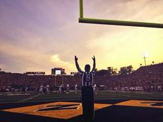 a football player raising his arms in the air