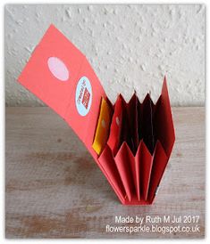 an origami red folder with stickers on it