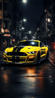 a yellow sports car driving down the street at night