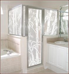 a bathroom with a glass shower door next to a sink and bathtub in front of a mirror