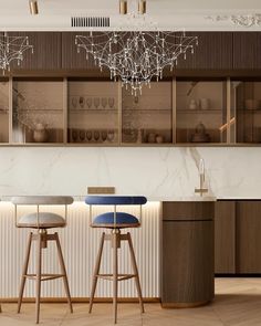 two bar stools in front of a counter