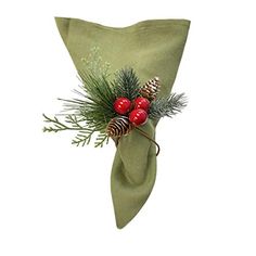 a green napkin with pine cones and berries on it