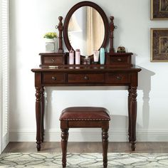 a dressing table with a mirror and stool