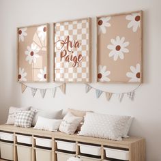 three framed pictures hang on the wall above a bench with pillows and baskets underneath them