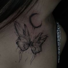 a woman's chest with a butterfly tattoo on the back of her left shoulder