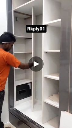 a man in an orange shirt is opening the shelves