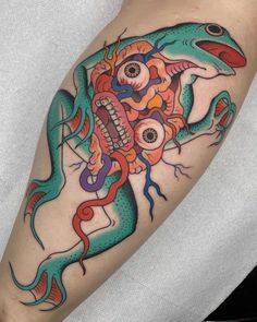 a colorful lizard tattoo on the arm