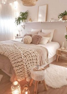 a bedroom with lights and blankets on the bed