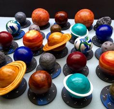 there are many different planets on the table with each one's own color and size