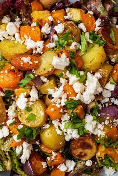 a salad with potatoes, carrots, onions and feta cheese on it in a white bowl