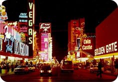 a city street filled with lots of neon signs and traffic lights at night in front of tall buildings