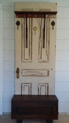 an old wooden bench sitting in front of a door with two books on top of it