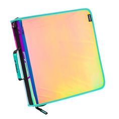 a rainbow colored notebook with a pen sticking out of the cover, on a white background