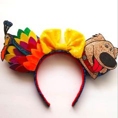 a colorful headband with an image of a bear and a turkey on it's side