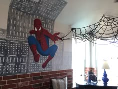 a spiderman mural on the wall of a living room