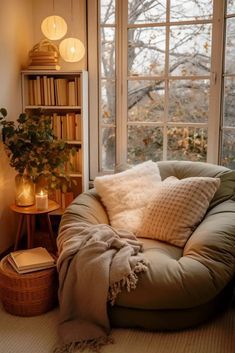 a living room filled with lots of furniture and a large window covered in bookshelves