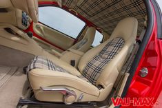 the interior of a car with beige leather seats and plaid upholstered seat covers