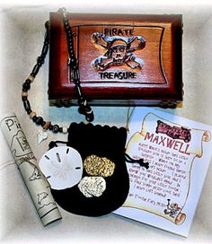 an assortment of items including a pirate chest and keychain are displayed on a table