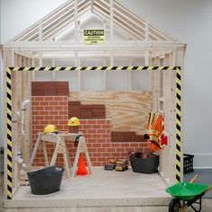 an unfinished room with construction equipment on the floor and around it is a brick wall