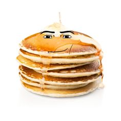 a stack of pancakes with a face drawn on it